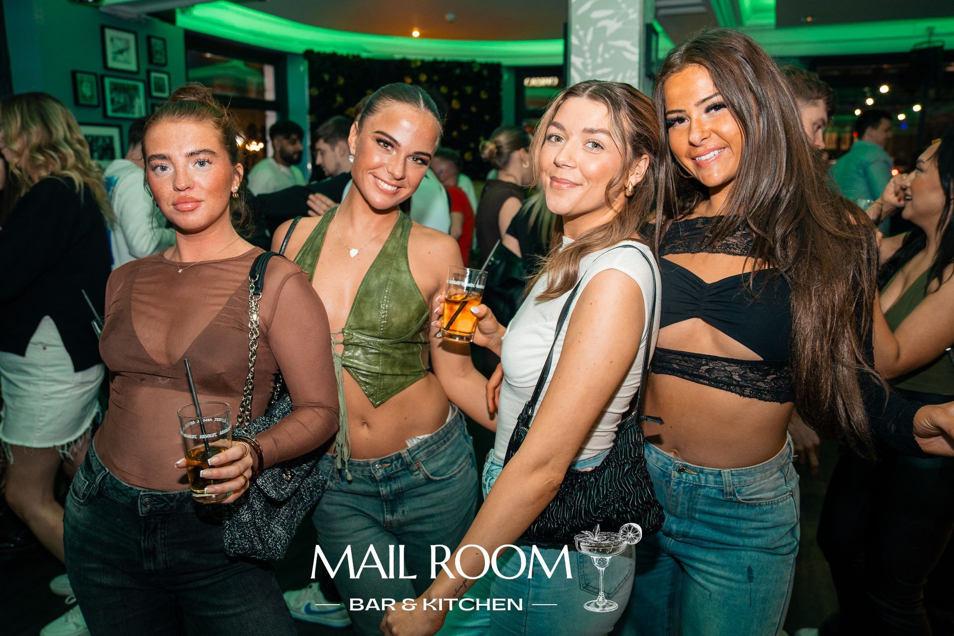 A group of women are posing for a picture at a party.