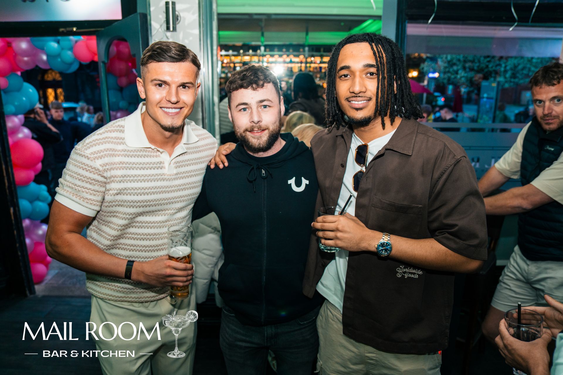 Three men are posing for a picture at a party.