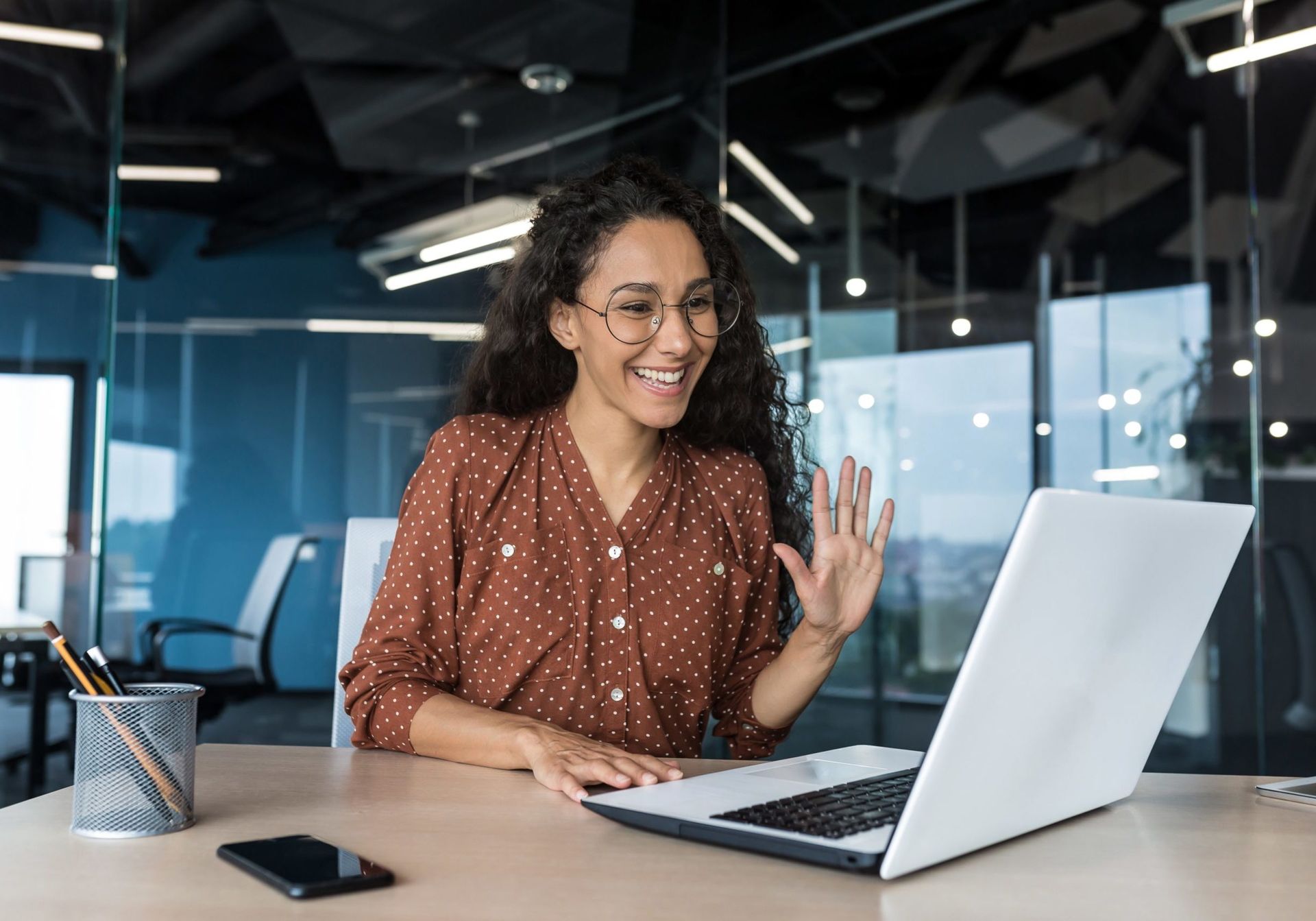 Successful hispanic woman working inside modern office building