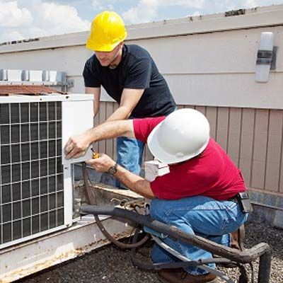 An Electrician Men Checking Air Conditioning Unit — Hempstead, TX — Waller County Electric & Air Conditioning
