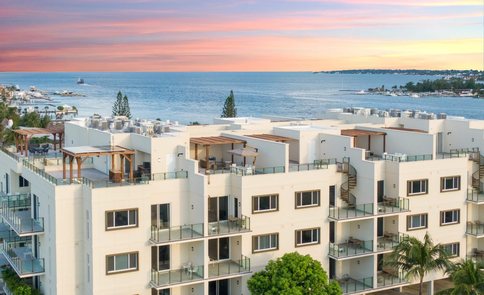 Beachfront facade of Aqualina with oceanview pool in Nassau, The Bahamas