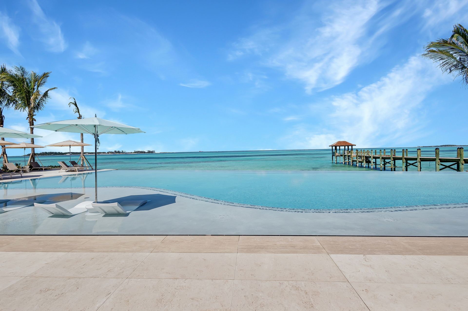 Infinity pool with beach view at Aqualina luxury beachfront property in Nassau, The Bahamas