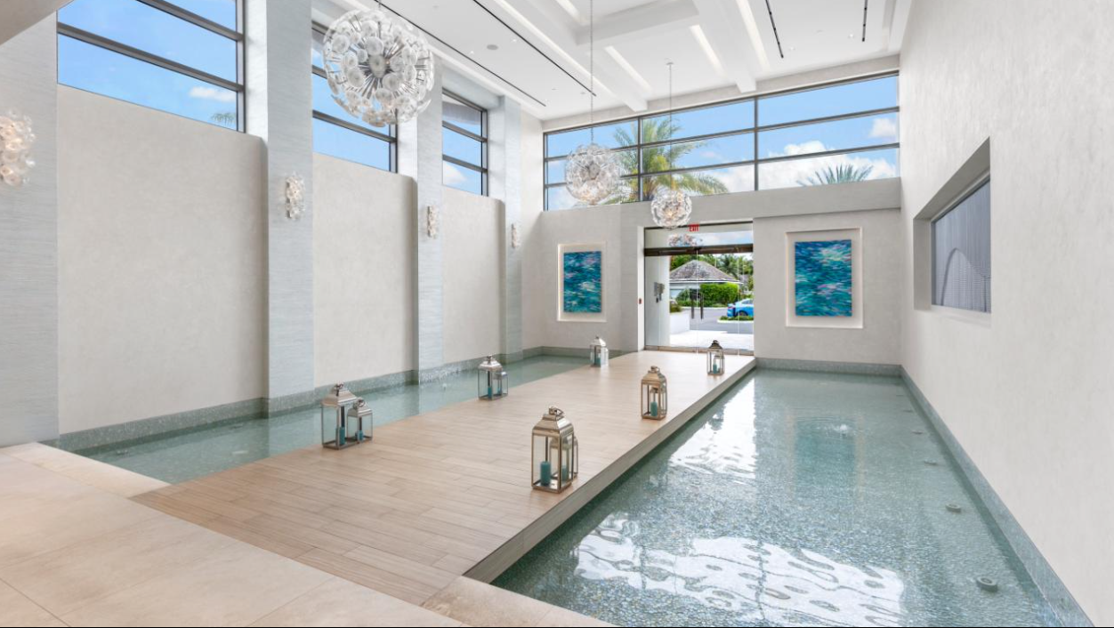 one cable beach lobby with pool with lanterns on the side of it.