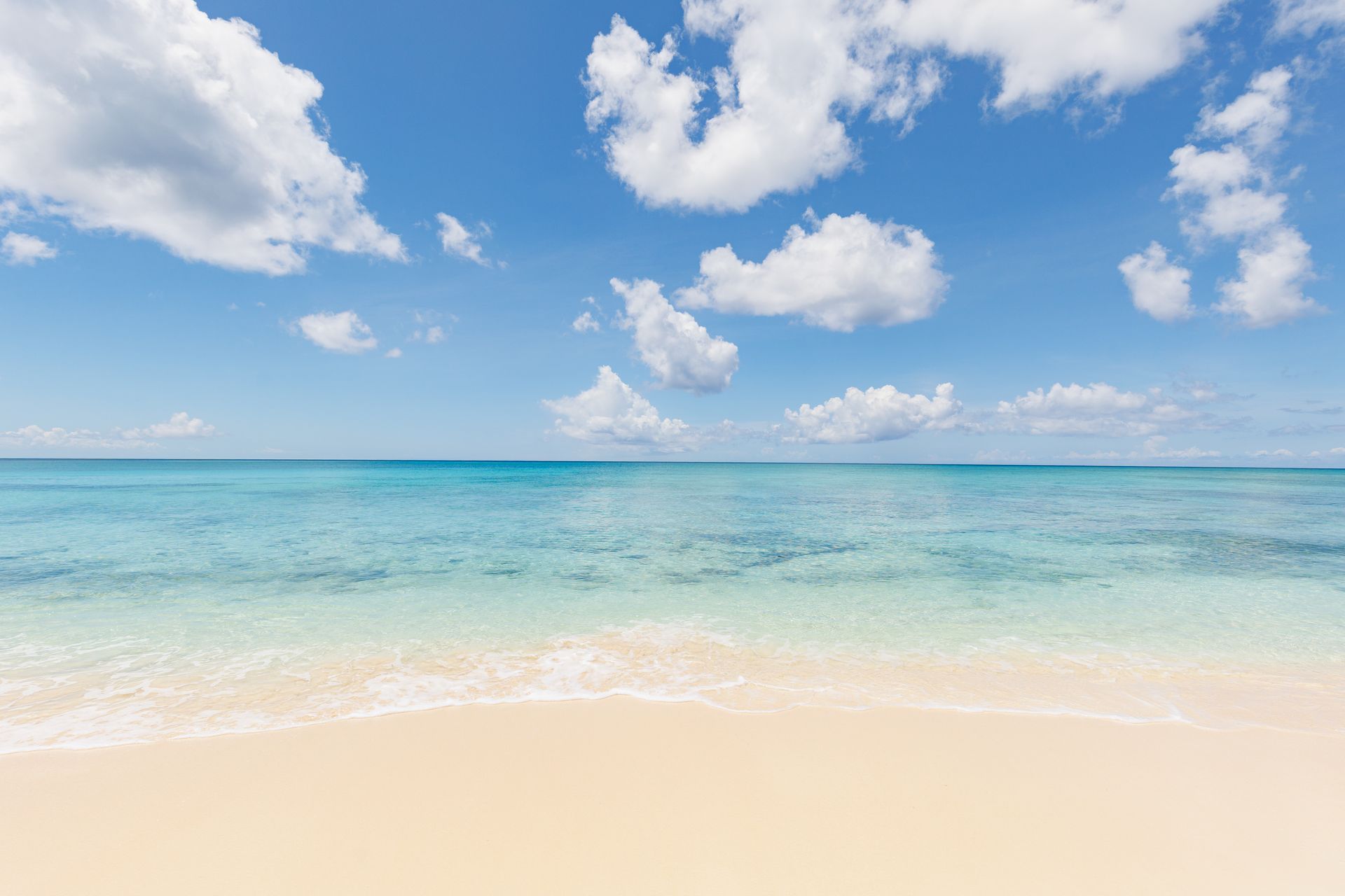 Spacious kitchen featuring island workspace in One Cable Beach condo in Nassau, Bahamas