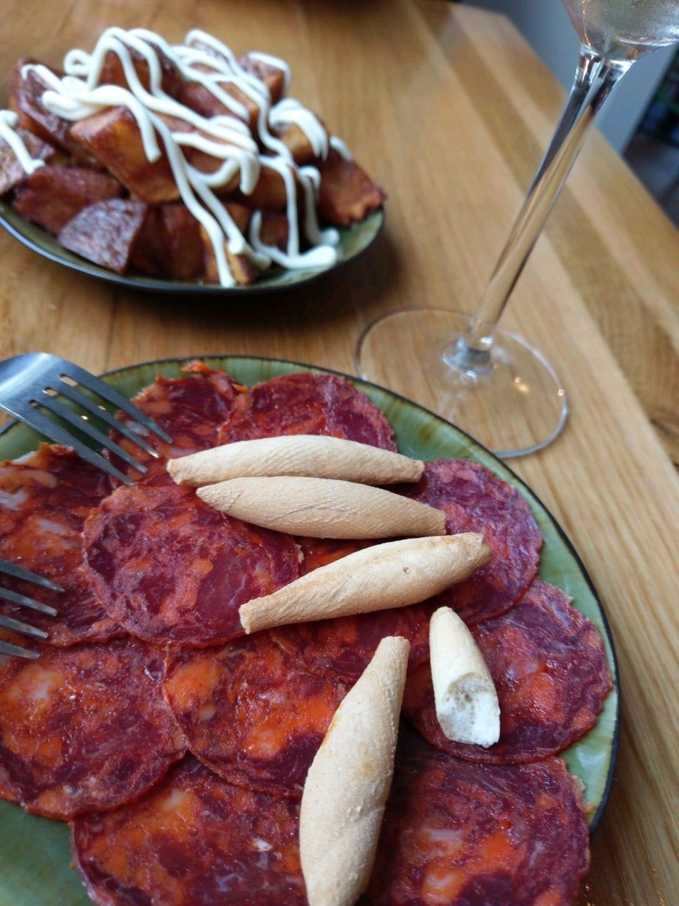 a plate of food and a glass of wine on a table