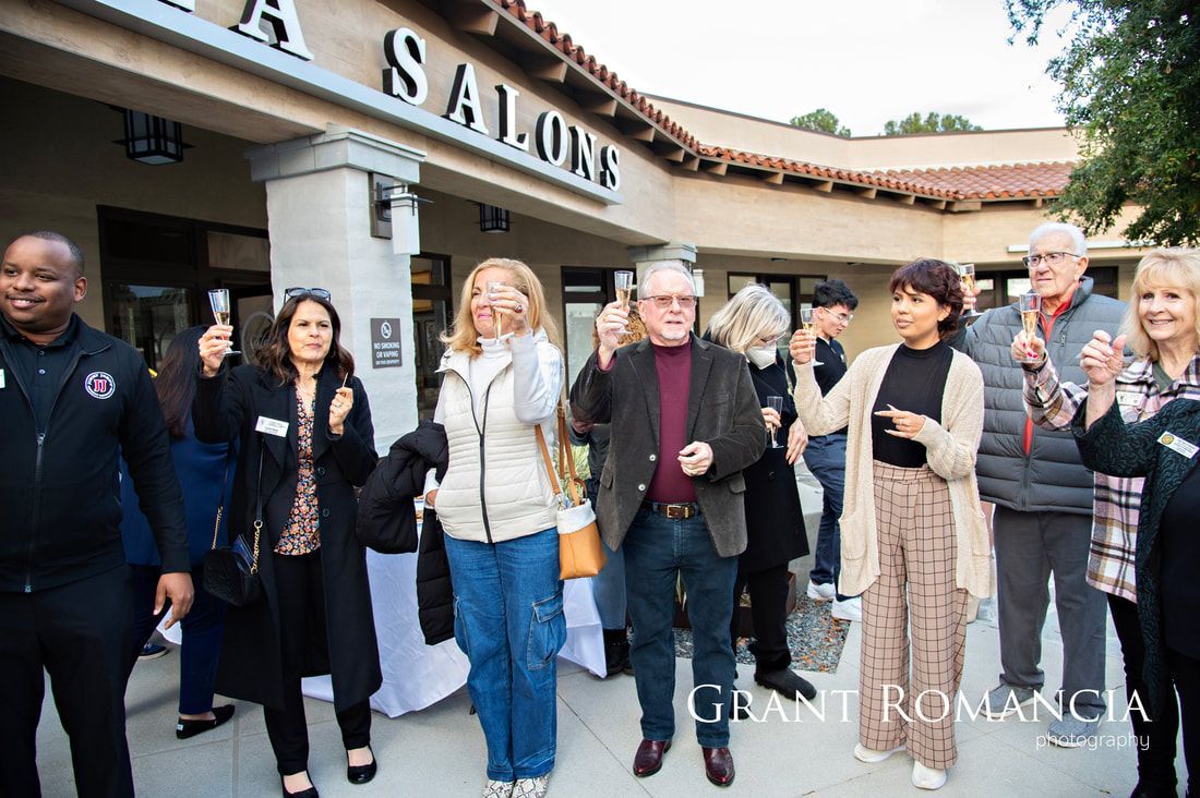 People toasting with glasses outside a building with