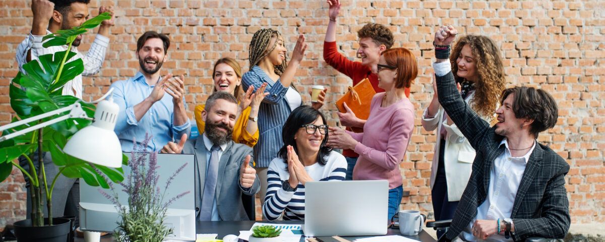 A group of people are posing for a picture in an office.