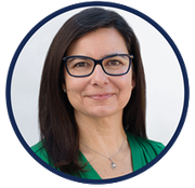 A woman wearing glasses and a green shirt is smiling in a circle.