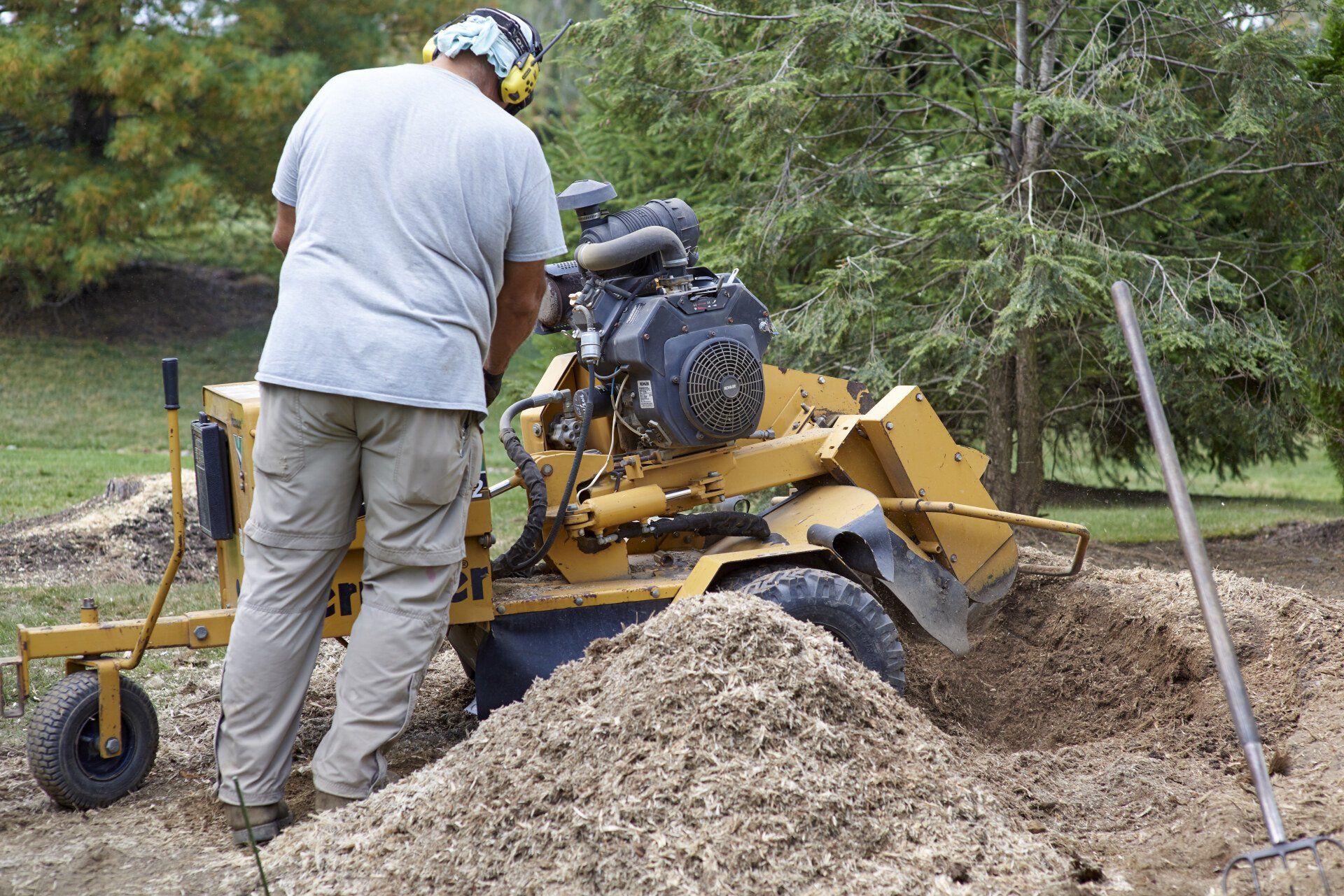 worker finishing up with stump grinder for stump removal