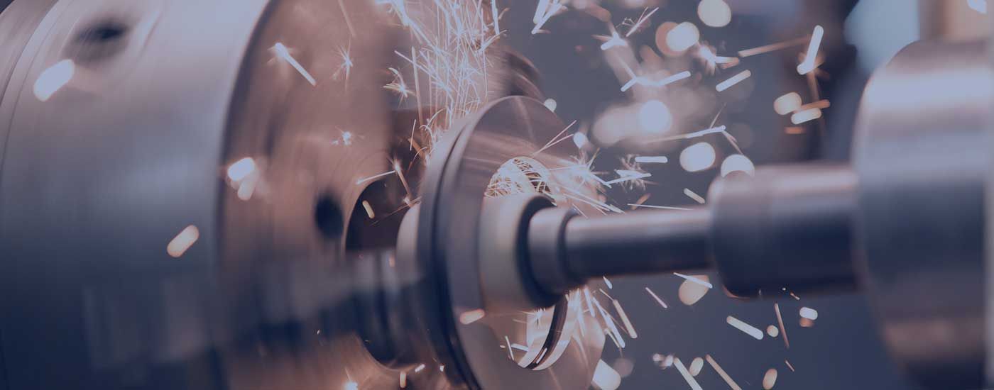 A machine is cutting a piece of metal in a factory.