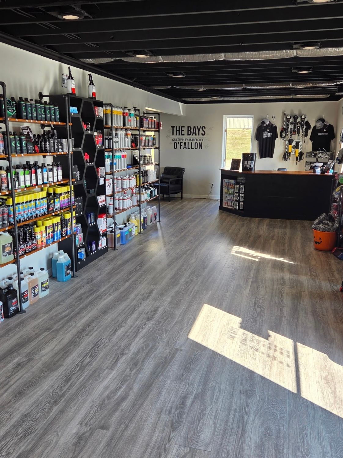 A store filled with lots of shelves and a chandelier.
