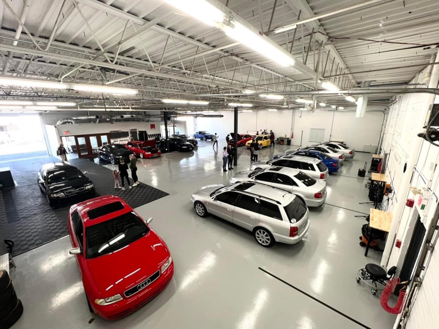 A lot of cars are parked in a garage.