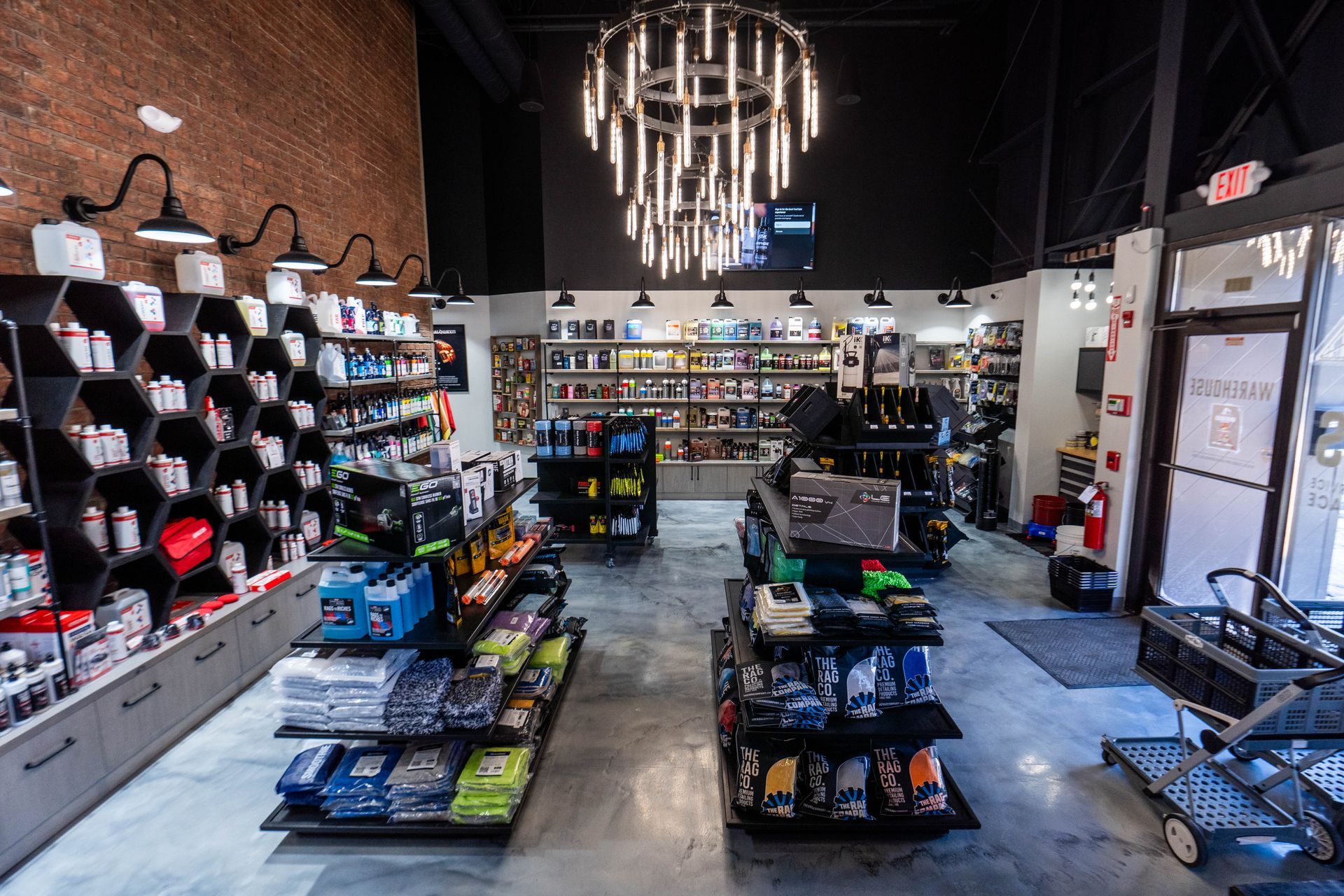 A store filled with lots of shelves and a chandelier.