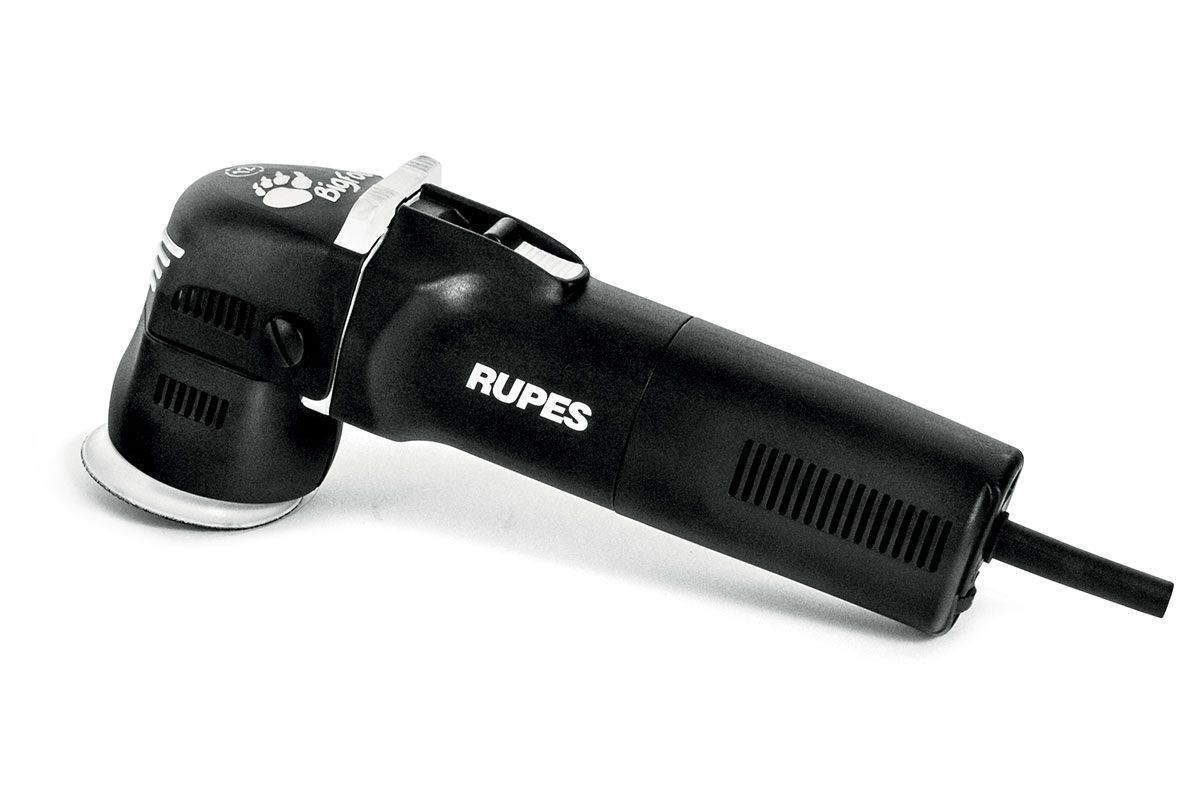 A black rupes machine is sitting on a white surface.