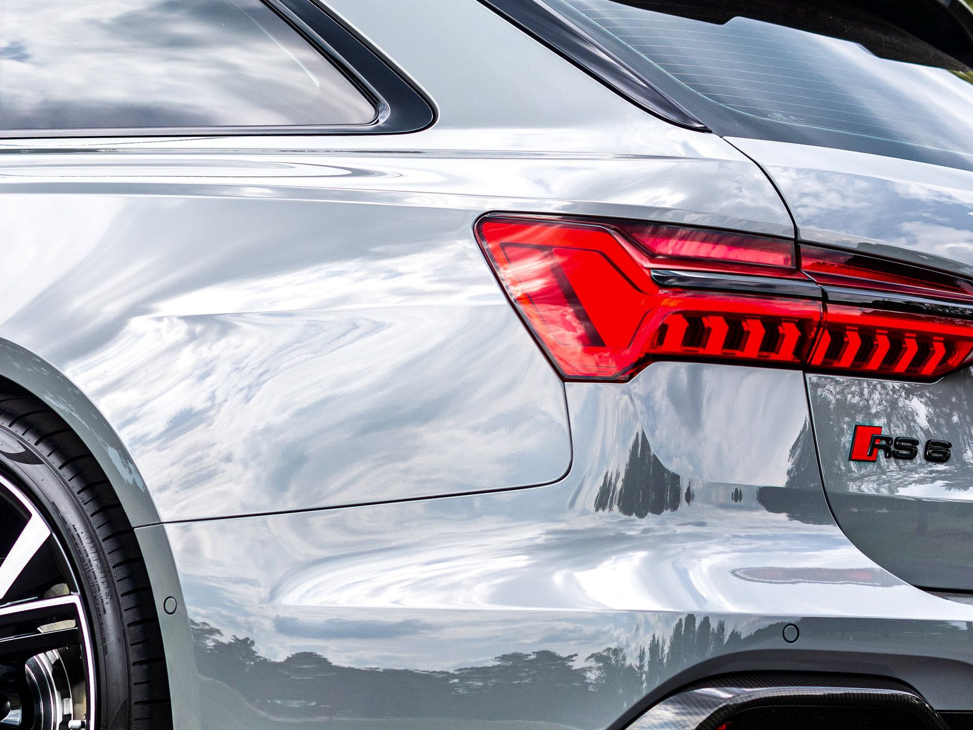 A silver audi rs6 with a red tail light