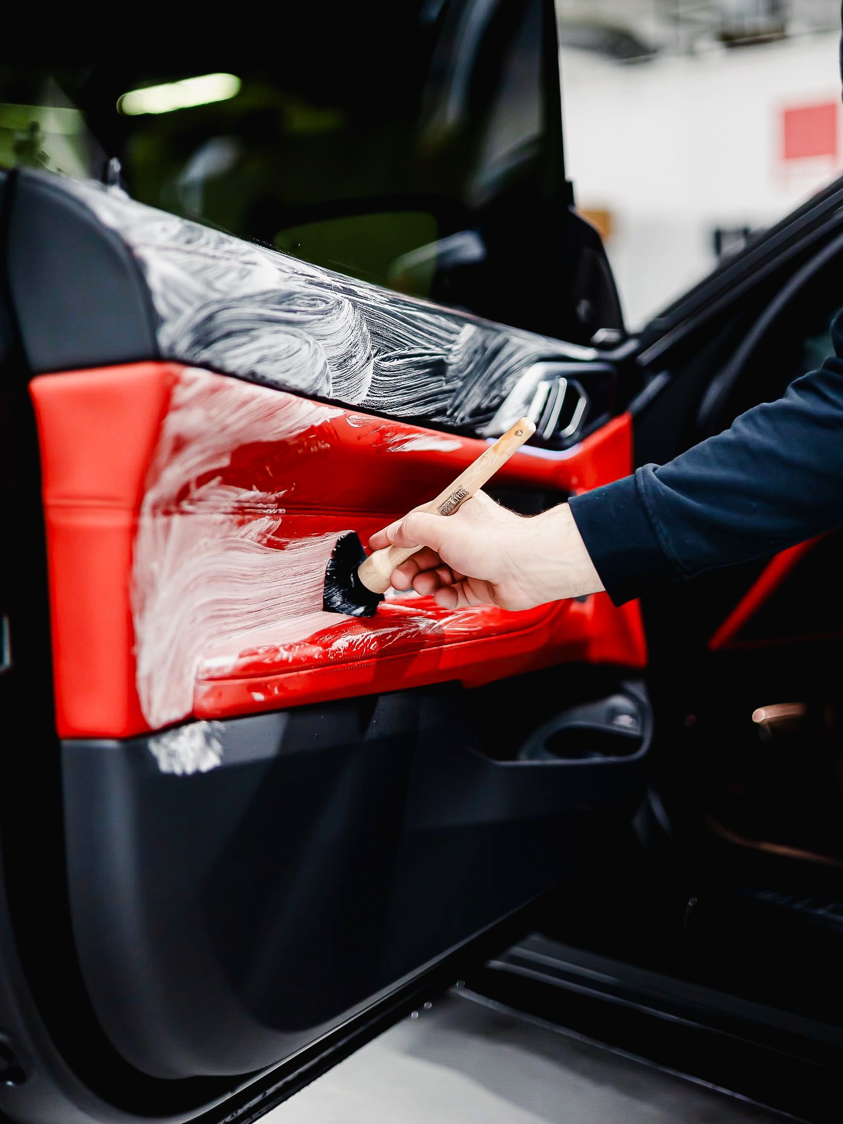 A group of men are standing around a table in a garage.