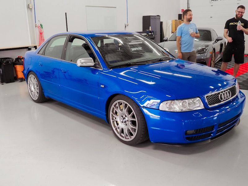 A blue audi car is parked in a garage