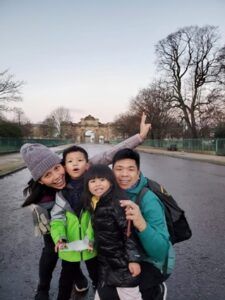 A family is posing for a picture on the side of the road.