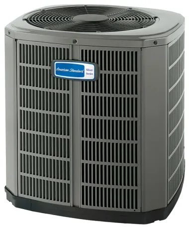 An air conditioning unit next to a house with a window. The unit is emitting vapor.