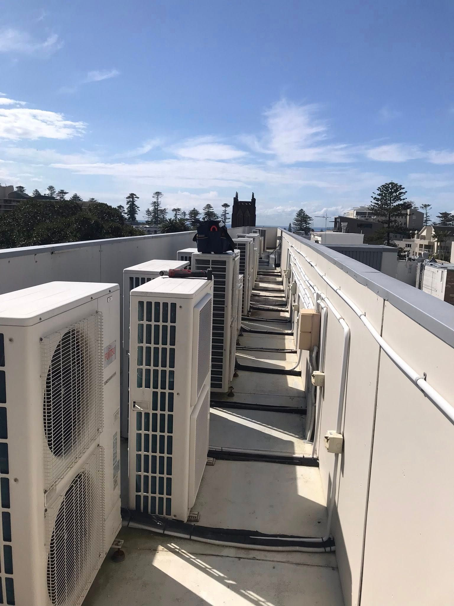 Row of White Air Conditioning Units on a Rooftop — Escarpment Air in Mount Saint Thomas, NSW