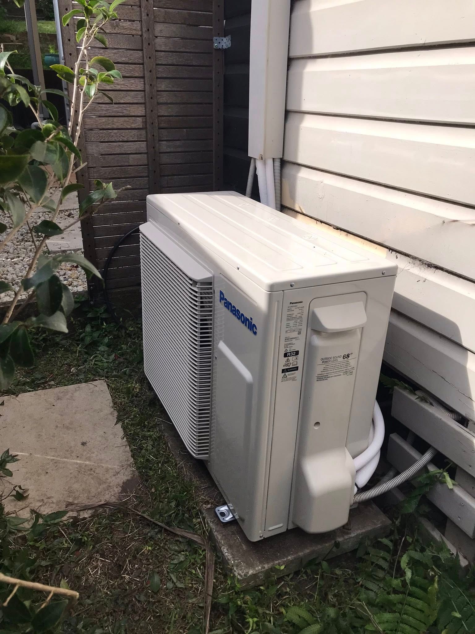 A Outdoor Air Conditioning Unit Next to a White Clapboard — Escarpment Air in Mount Saint Thomas, NSW
