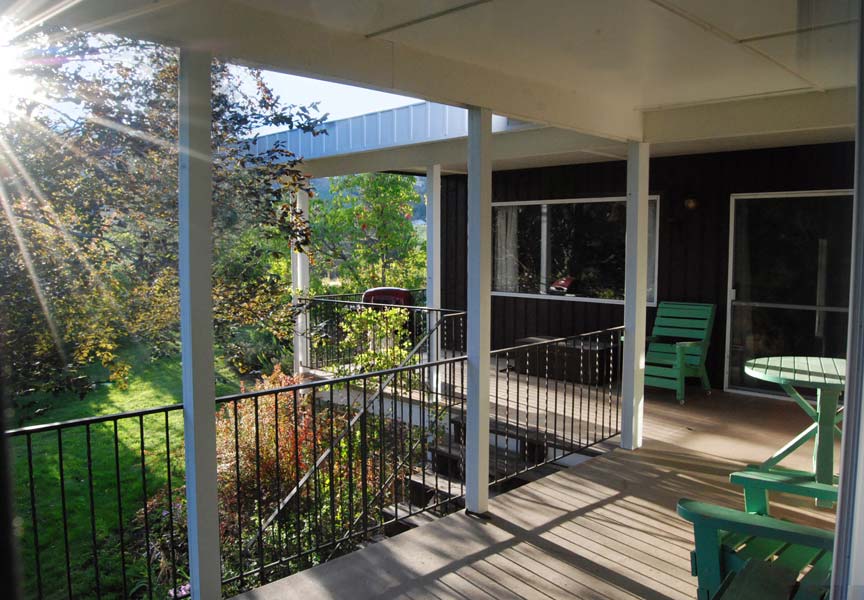 A porch with a table and chairs on it