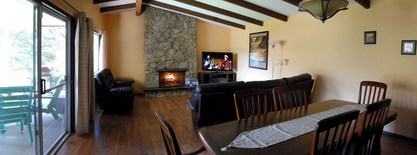 A living room with a table and chairs and a fireplace