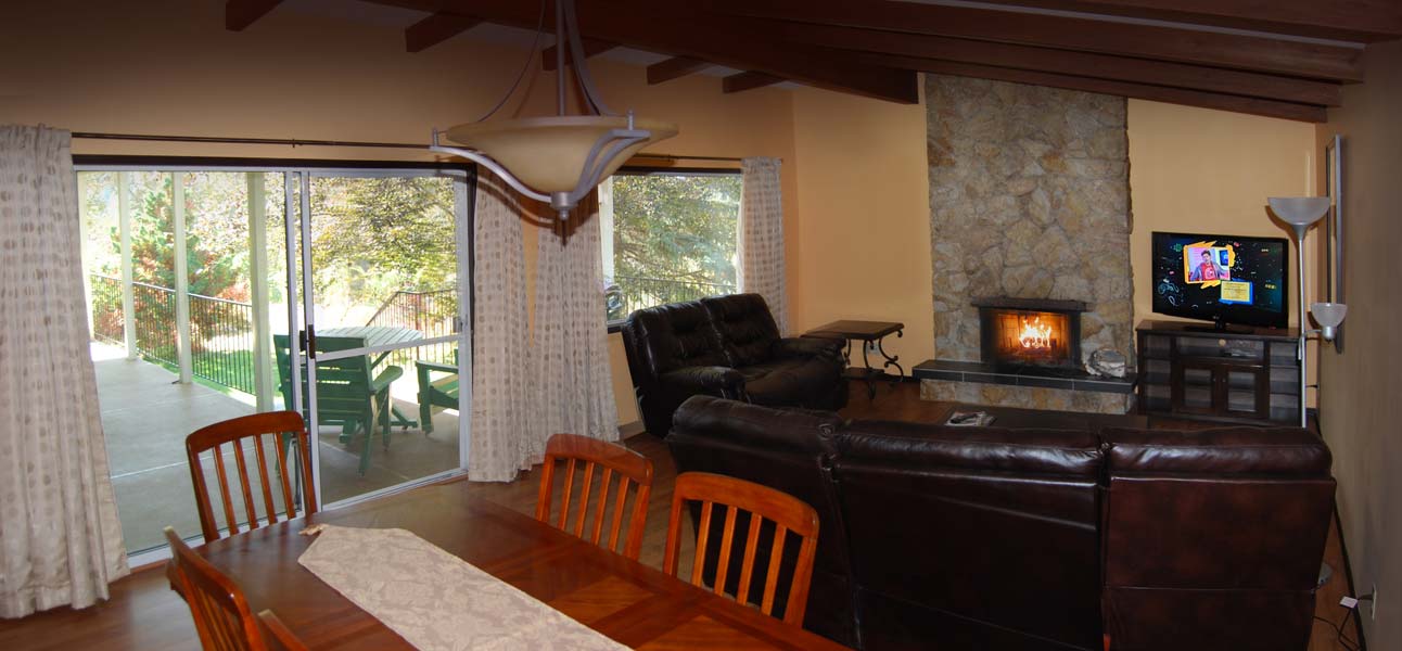 A living room with a table and chairs and a fireplace