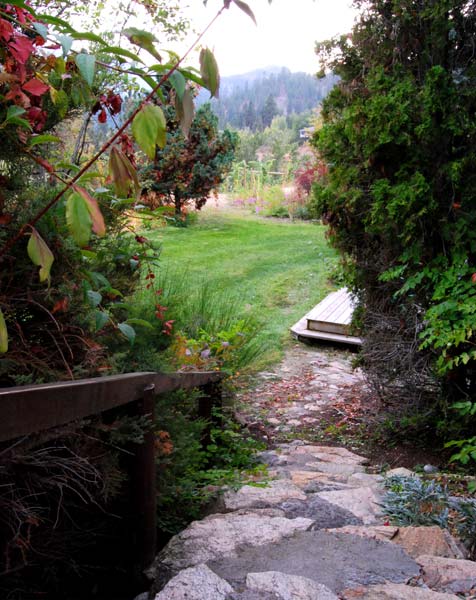 A stone path leads to a lush green field