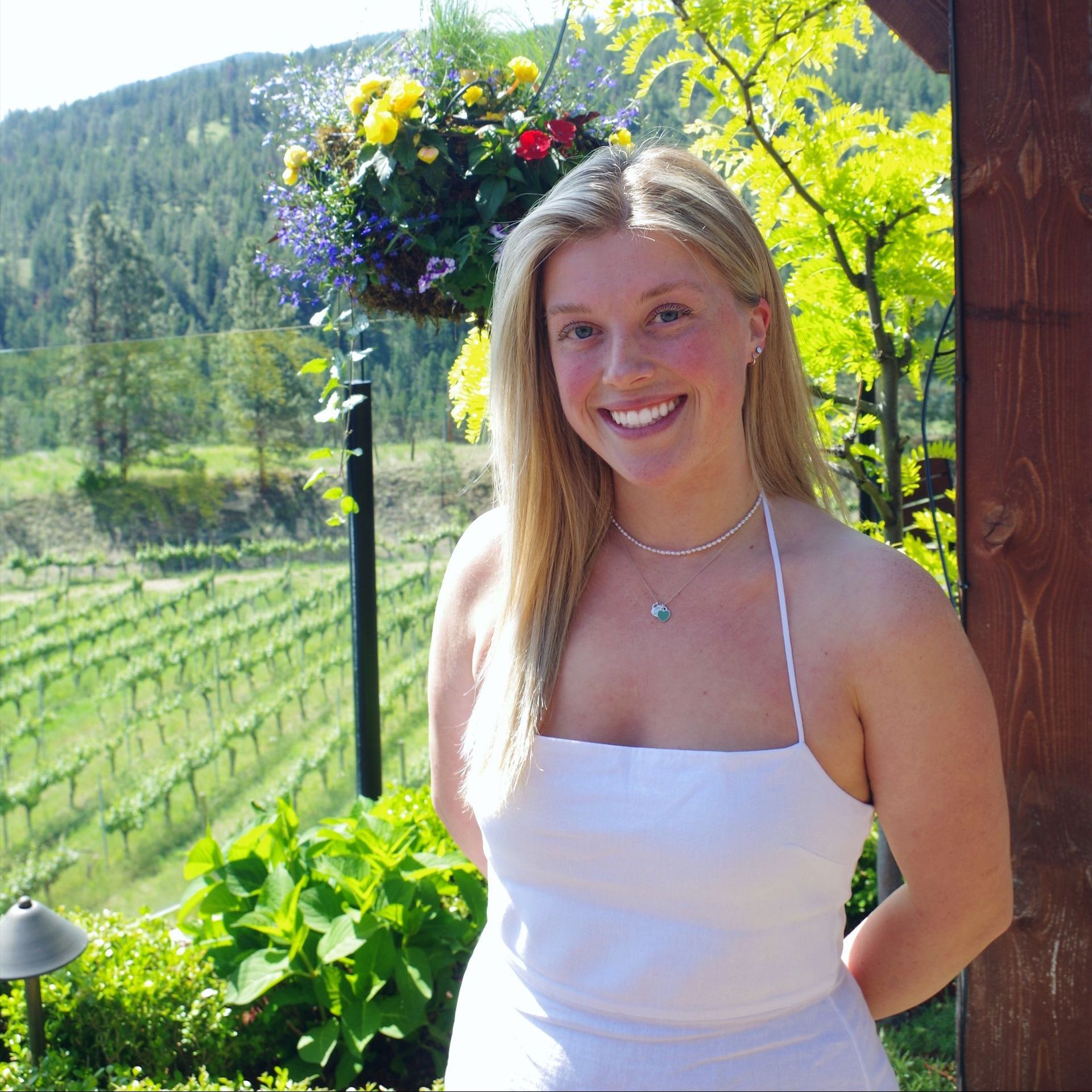 A woman wearing glasses is holding a glass of wine