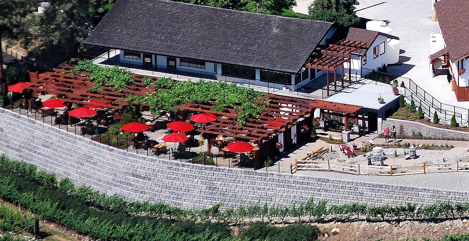 An aerial view of a restaurant with red umbrellas