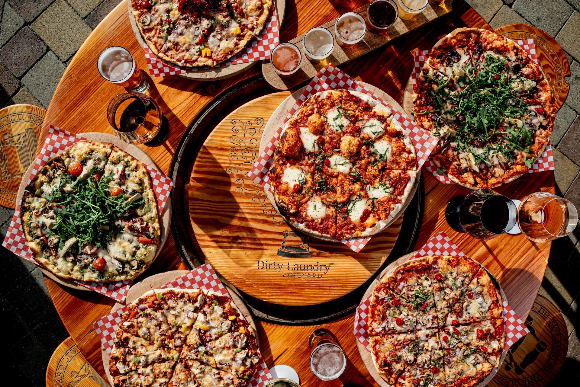There are many different types of pizzas on the table.