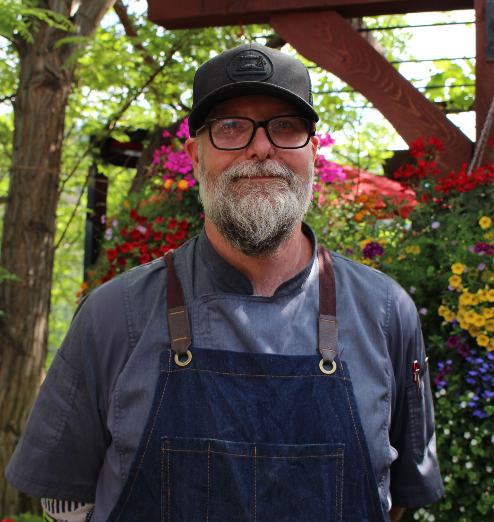 A woman is holding a glass of wine in a wine cellar.
