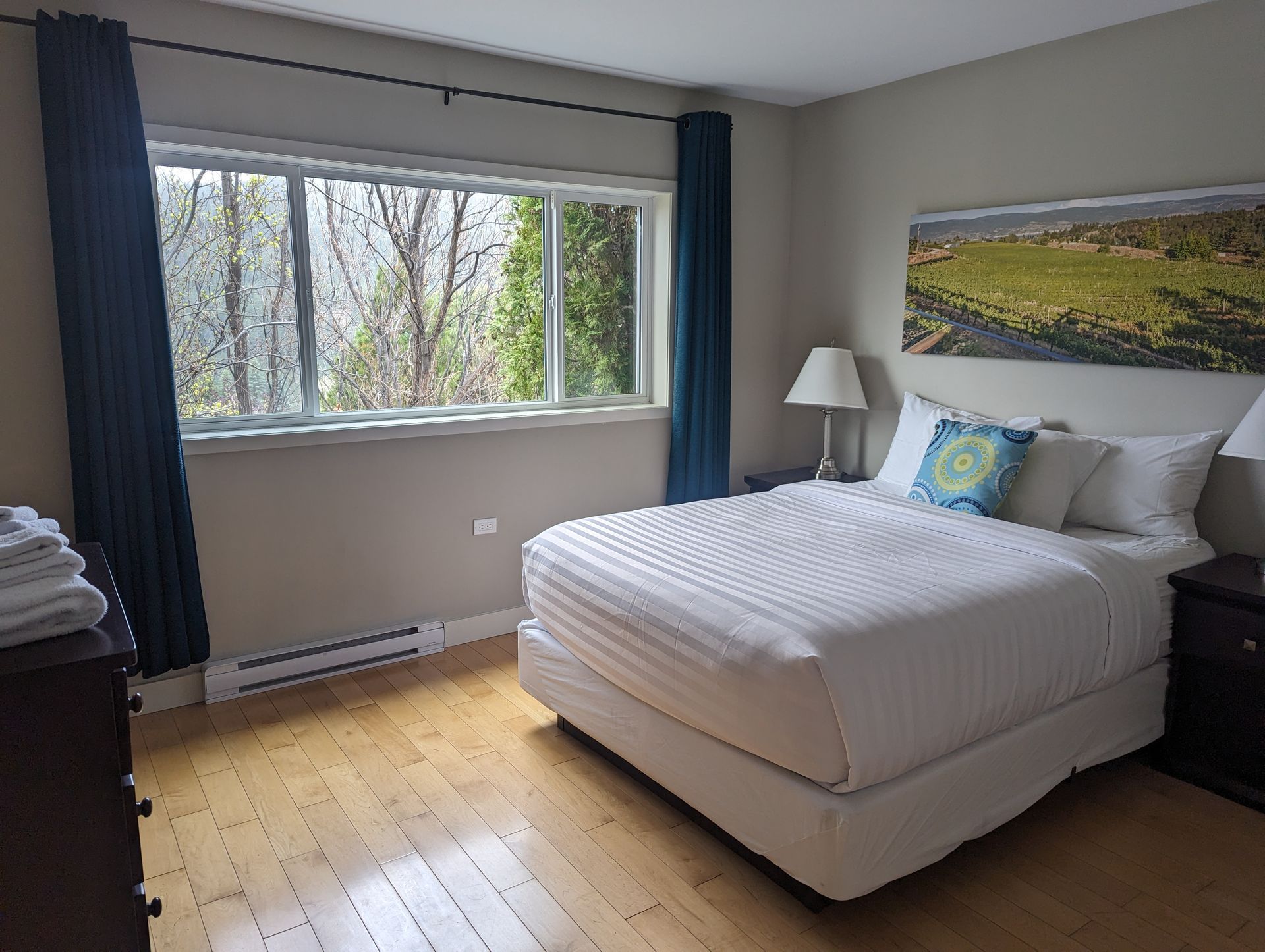 A bedroom with a large bed and a large window.