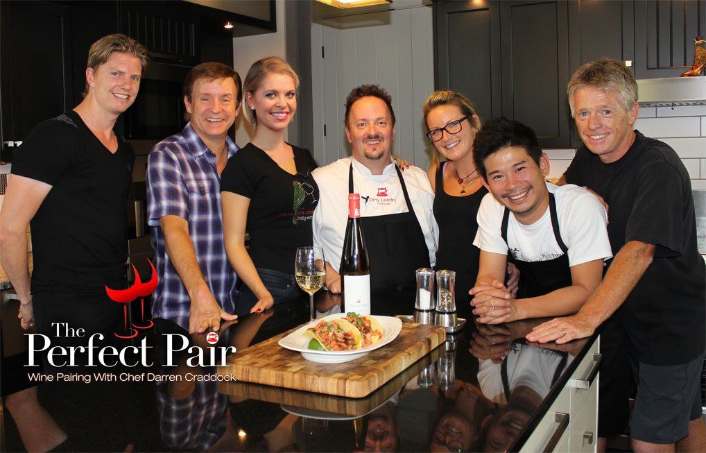 A group of people posing for a picture in a kitchen with the perfect pair written on the bottom