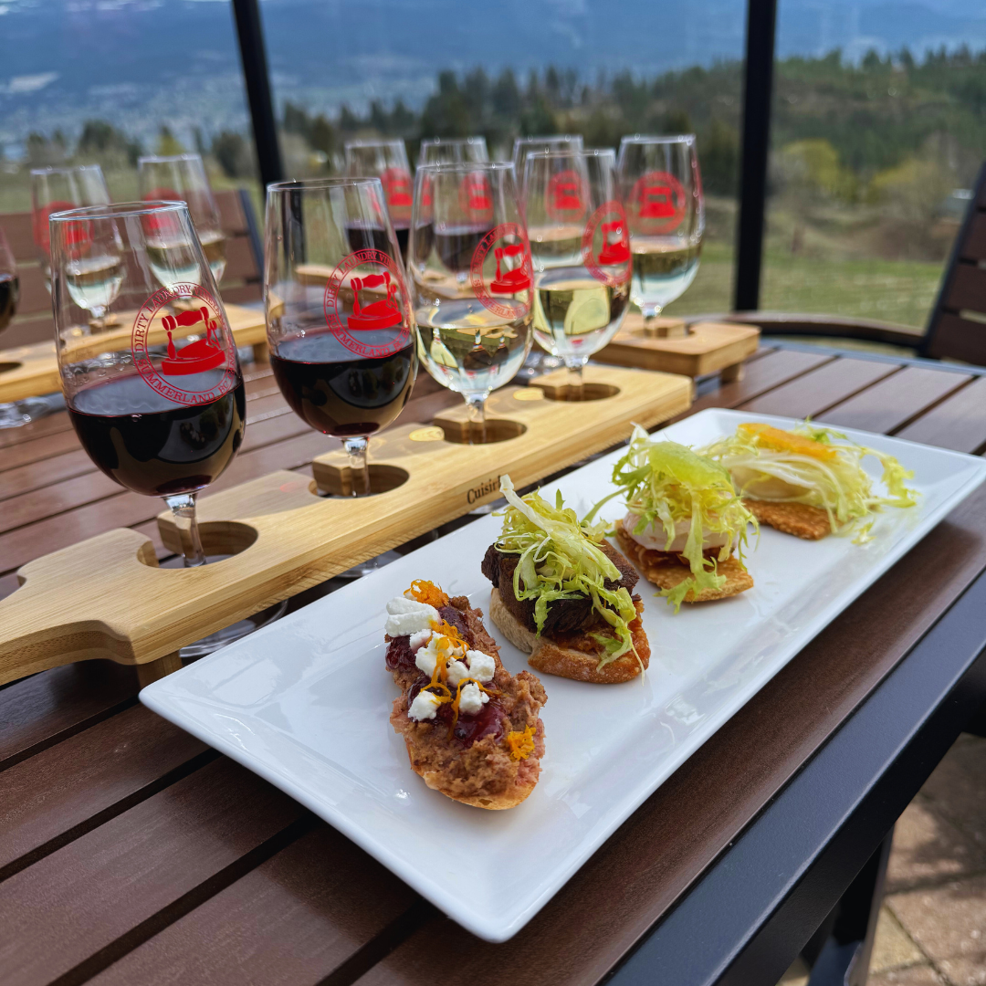 A plate of food and wine glasses on a table