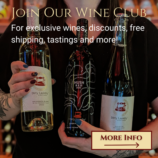 A person is holding a bottle of wine that says join our wine club