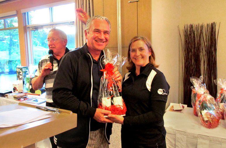 A man is giving a gift to a woman in a room