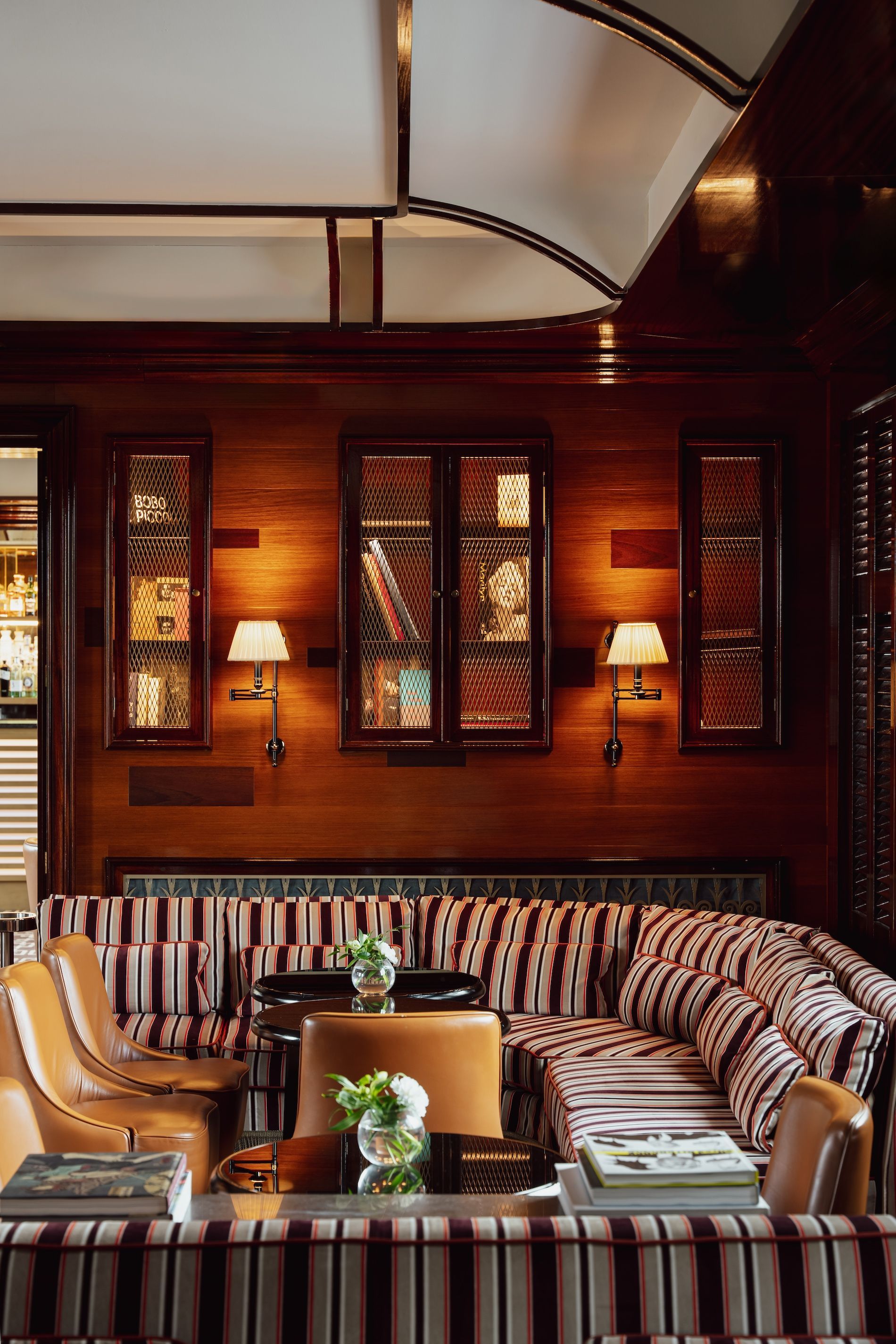 A living room with a striped couch and chairs