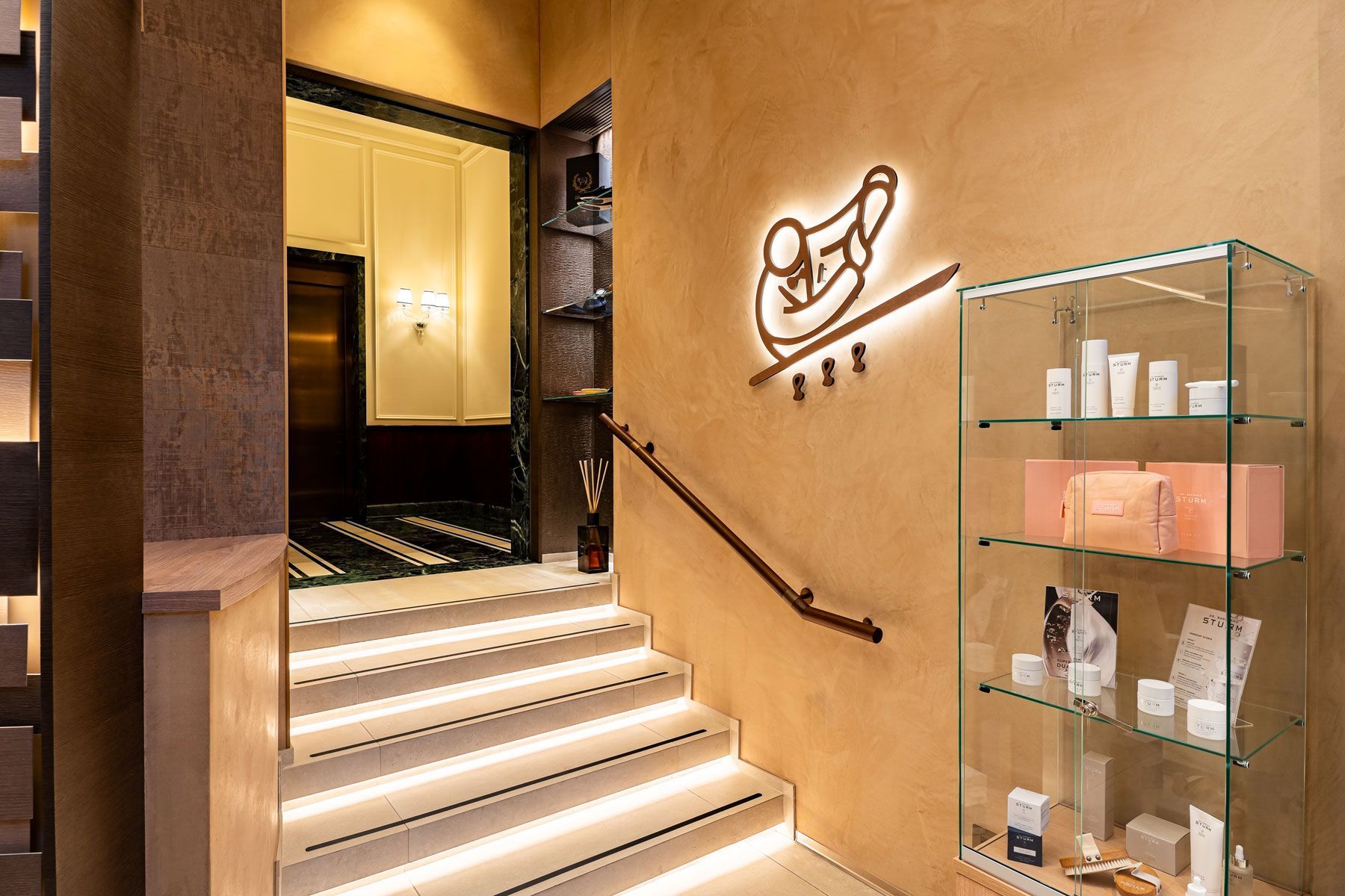 : Casa Cipriani Milano spa lobby with luxury skincare retail selection, offering premium beauty products in a stylish setting.