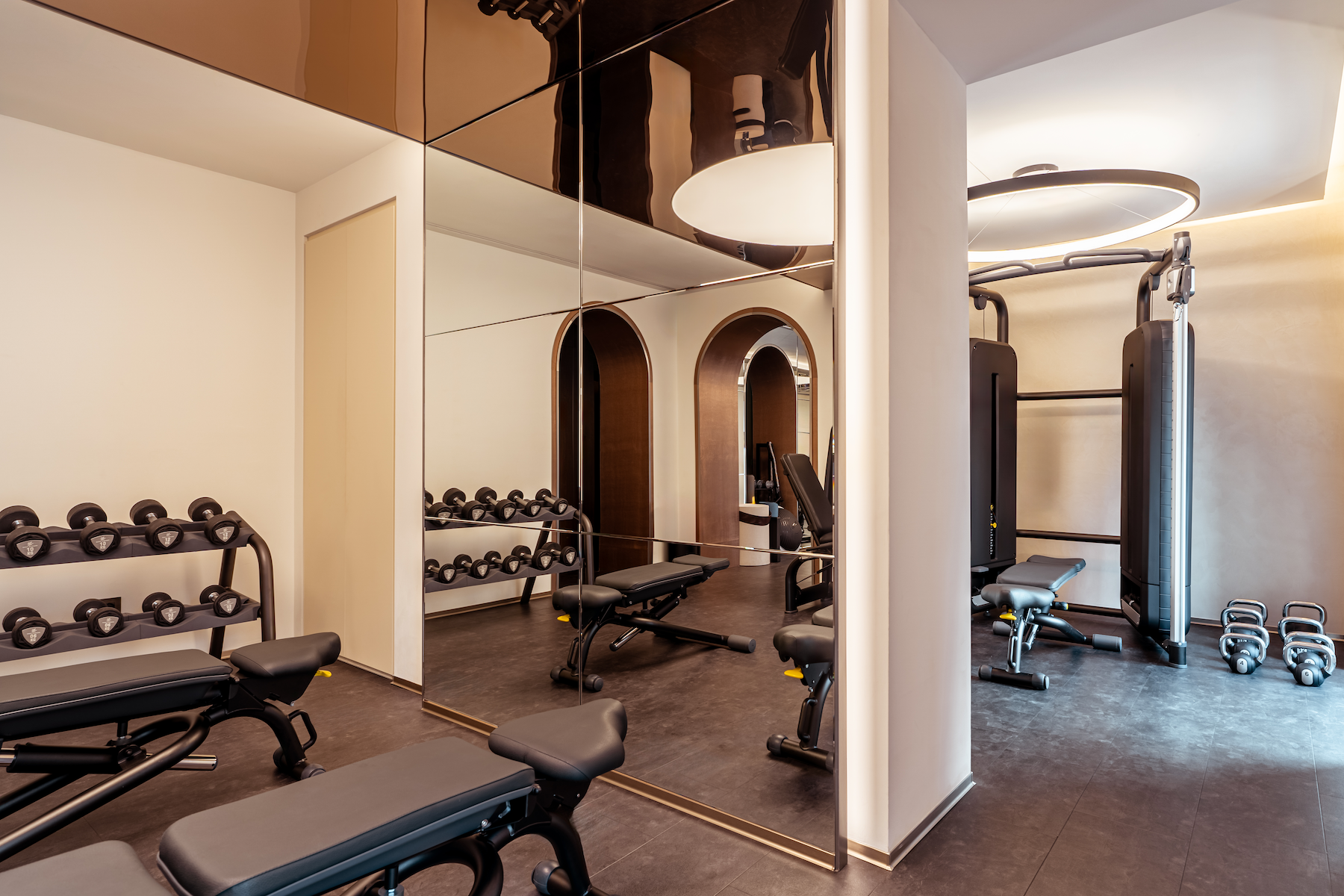 Casa Cipriani Milano gym with separate areas for weight training and strength exercises.