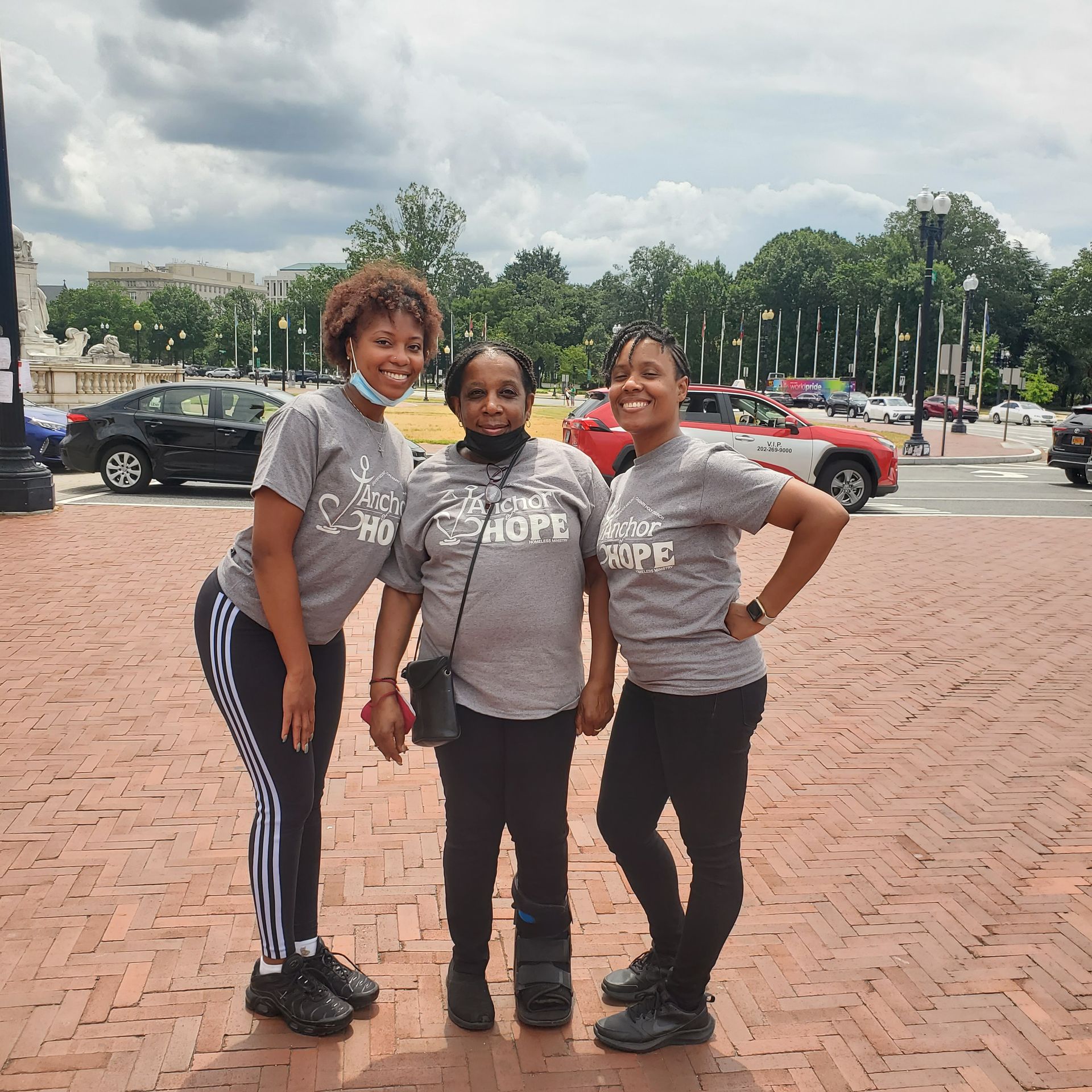 Three women wearing shirts that say hope are posing for a picture