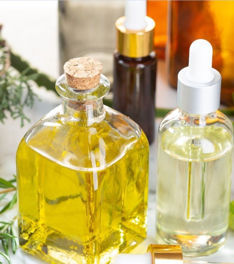 A bottle of oil with a cork on top of it