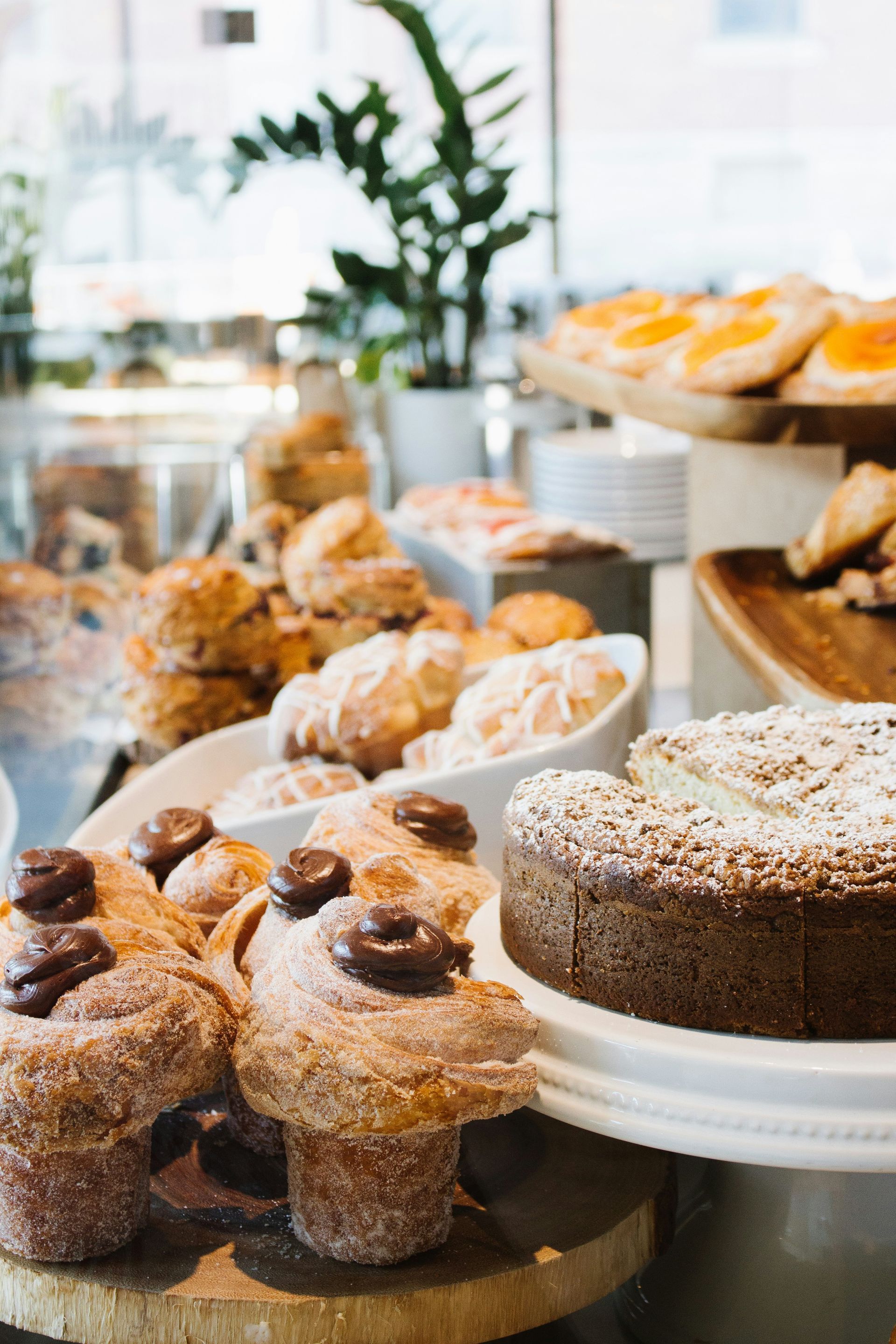 A variety of pastries are on display in a bakery.