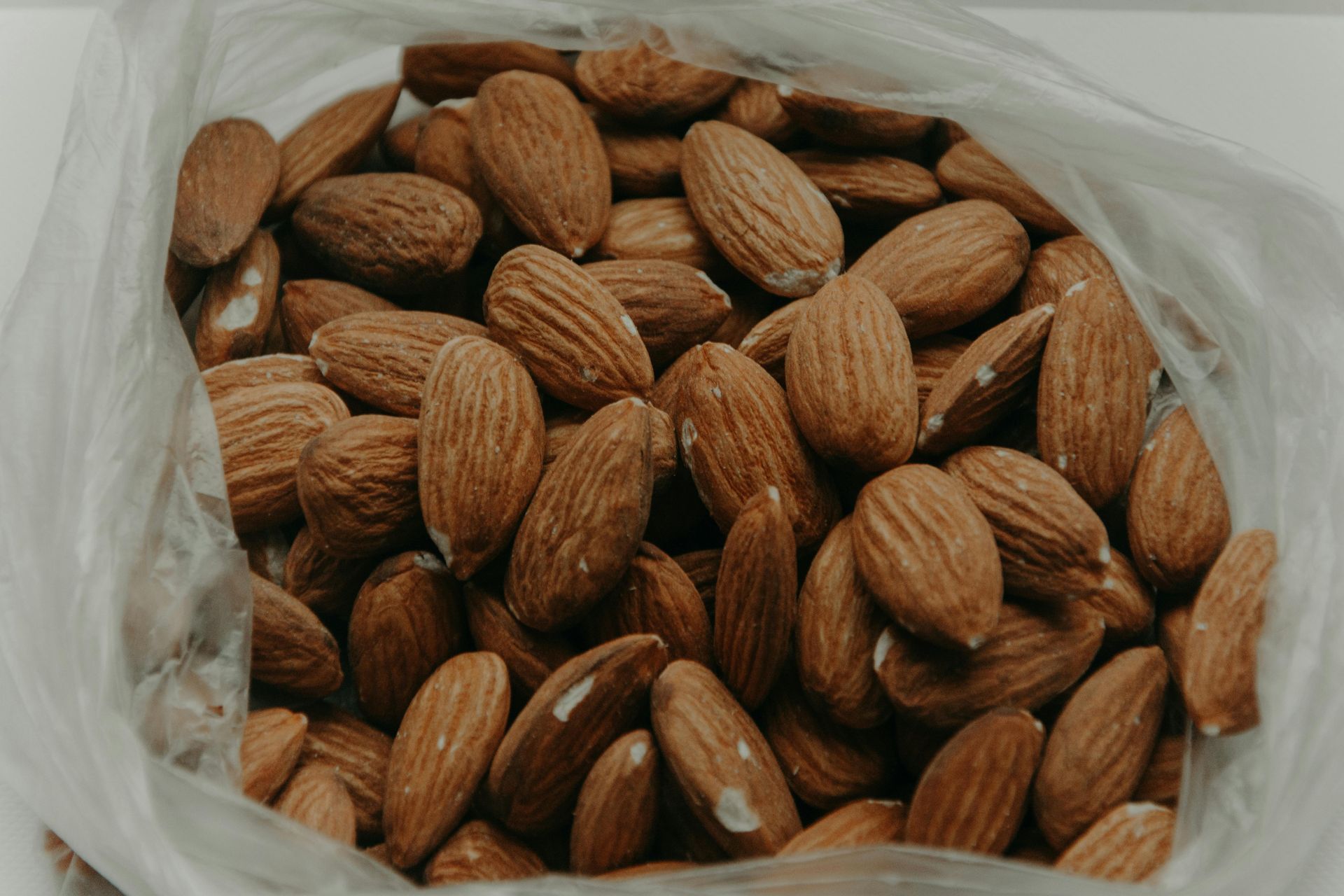 A bag of almonds is sitting on a table.