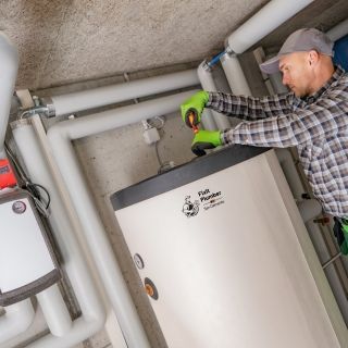 San Clemente plumber in a plaid shirt is working on a water heater .(NOT tankless)