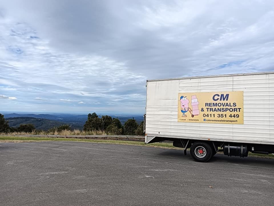 A moving truck is parked on the side of the road in a parking lot. — CM Removals & Transport In Hervey Bay, QLD