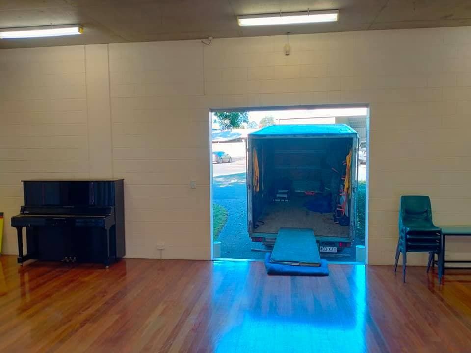 a Room With a Piano and a Van in It — CM Removals & Transport In Gympie, QLD
