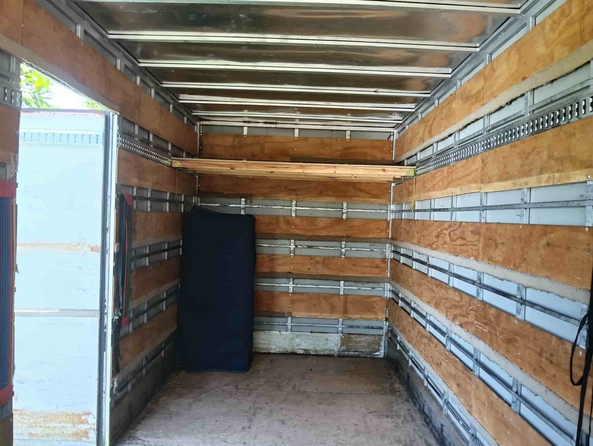 the Inside of a Moving Truck With Wooden Walls and Shelves — CM Removals & Transport In Tin Can Bay, QLD