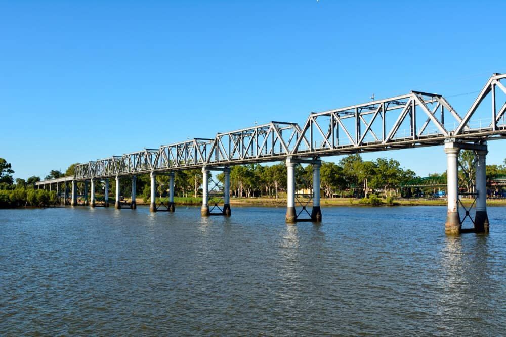 a Bridge Over a Body of Water With Trees in the Background — CM Removals & Transport In Bundaberg, QLD